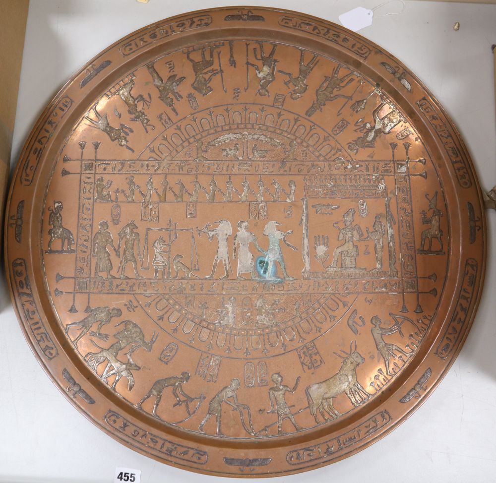 A large circular copper tray with white metal inlay depicting ancient Egyptian scenes, diameter 61cm